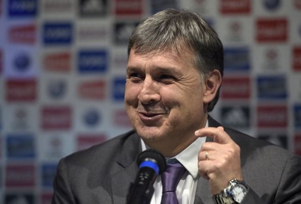 Argentina's national football team coach Gerardo Martino smiles during a press conference in Ezeiza, Buenos Aires, Argentina on August 14, 2014 during his presentation as new coach of Argentina's squad.  AFP PHOTO / JUAN MABROMATA