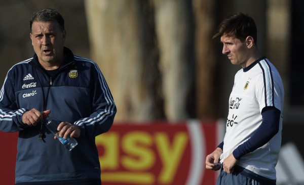 Argentina's forward Lionel Messi (R) listens to coach Gerardo Martino during a training session in La Serena, Coquimbo, Chile, on June 23, 2015 ahead the Copa America quarterfinal football match against Colombia to be held in Vina del Mar on June 26. AFP PHOTO / JUAN MABROMATA        (Photo credit should read JUAN MABROMATA/AFP/Getty Images)